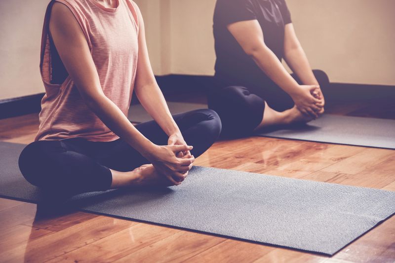 <span  class="uc_style_uc_tiles_grid_image_elementor_uc_items_attribute_title" style="color:#ffffff;">Group of young healthy Asian women practicing yoga  lesson with instructor in home studio, wellness and fitness lifestyle concept, new year 2020 resolution</span>